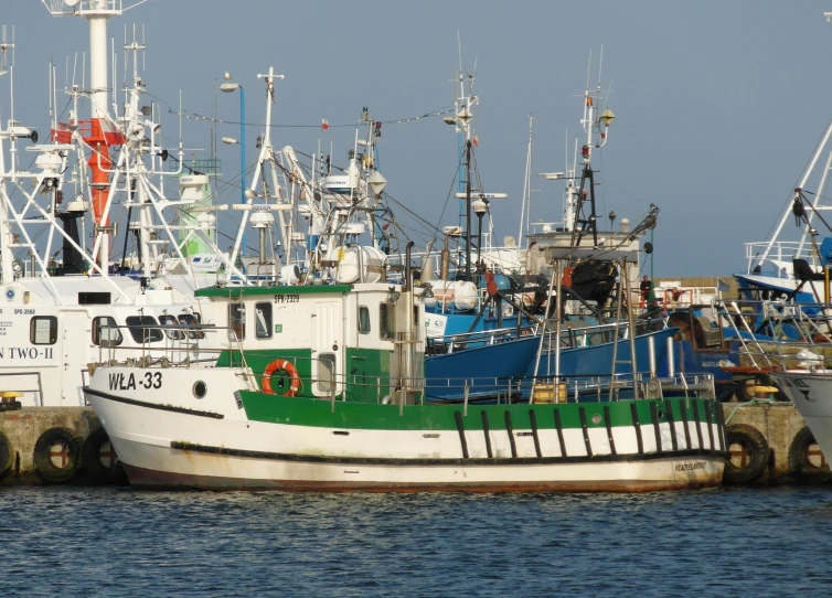 several boats docked at the dock on a sunny day