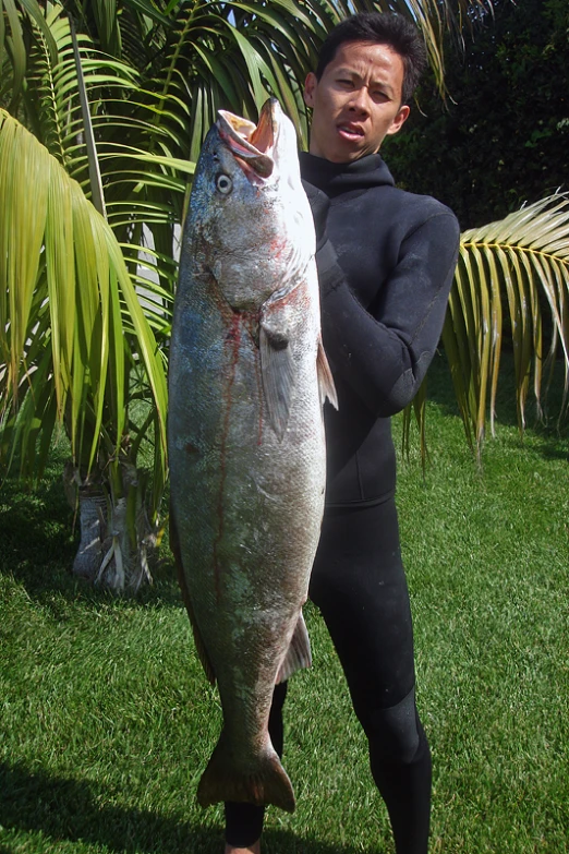 man holding up a fish that he caught