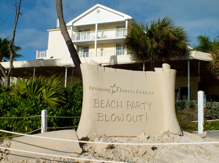 a sand castle in front of a beach house