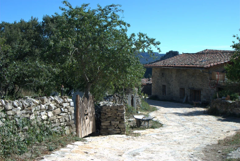 a small house is on the side of a road