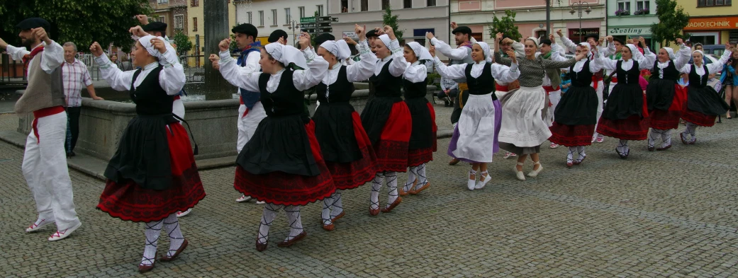 a group of s in fancy dresses on the streets of town