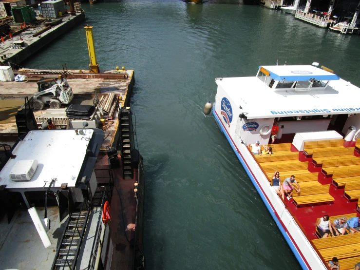 two boats parked at the dock next to each other