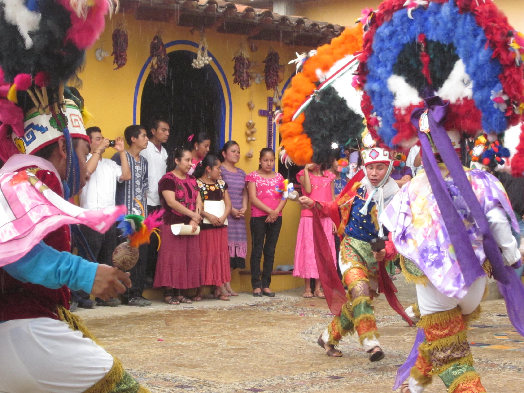 some people standing around each other with dance costumes