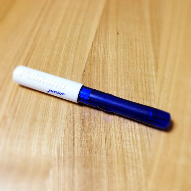 a pen sitting on top of a wooden table