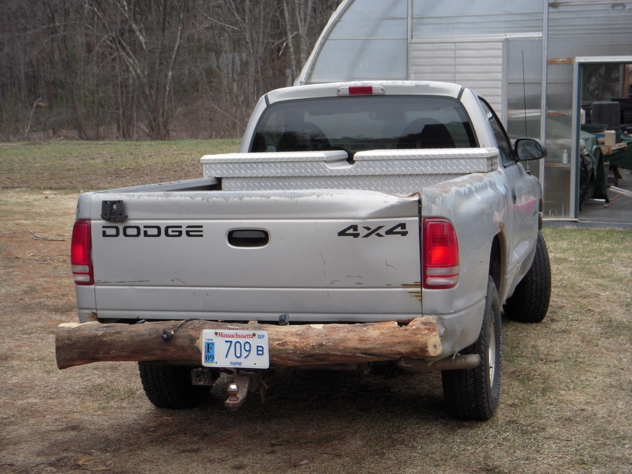 a pick up truck parked in a yard next to a building