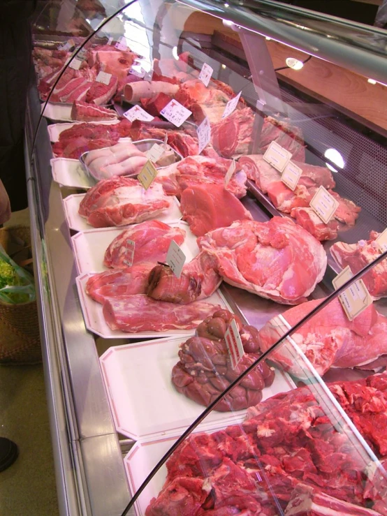 a market store filled with assorted meats and vegetables