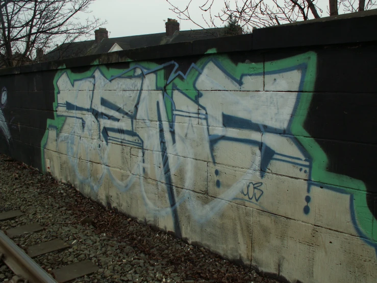 there are many different graffiti written on the side of the wall