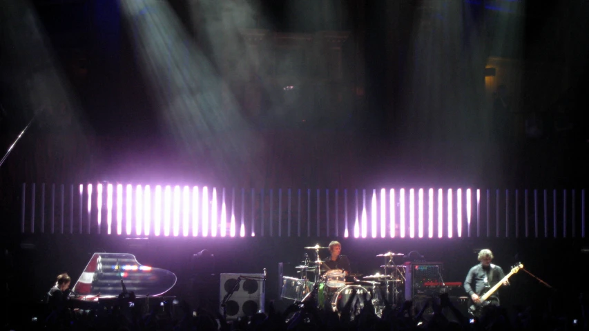 a couple of drummers in front of two band lights