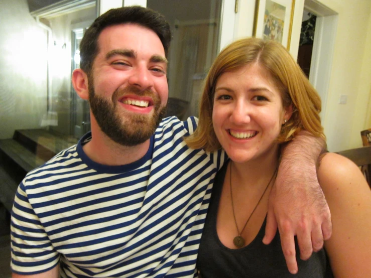 smiling young man and woman posing for a po