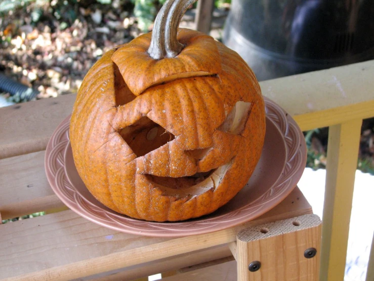 pumpkin carving on plate outdoors in the fall