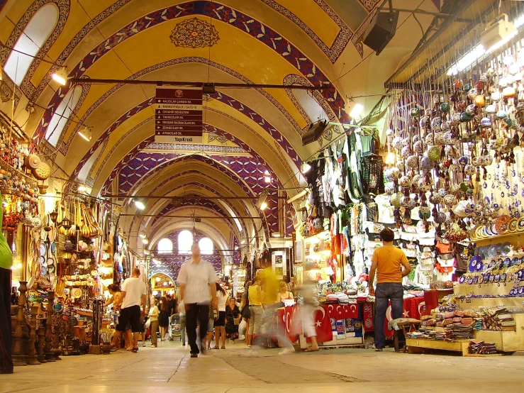 a crowded market is shown with lots of goods