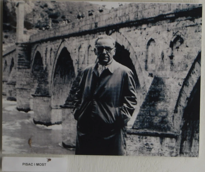 a black and white picture of a man wearing glasses