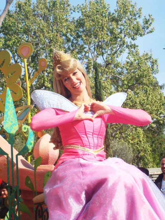 a  dressed in a pink dress with fairy ears