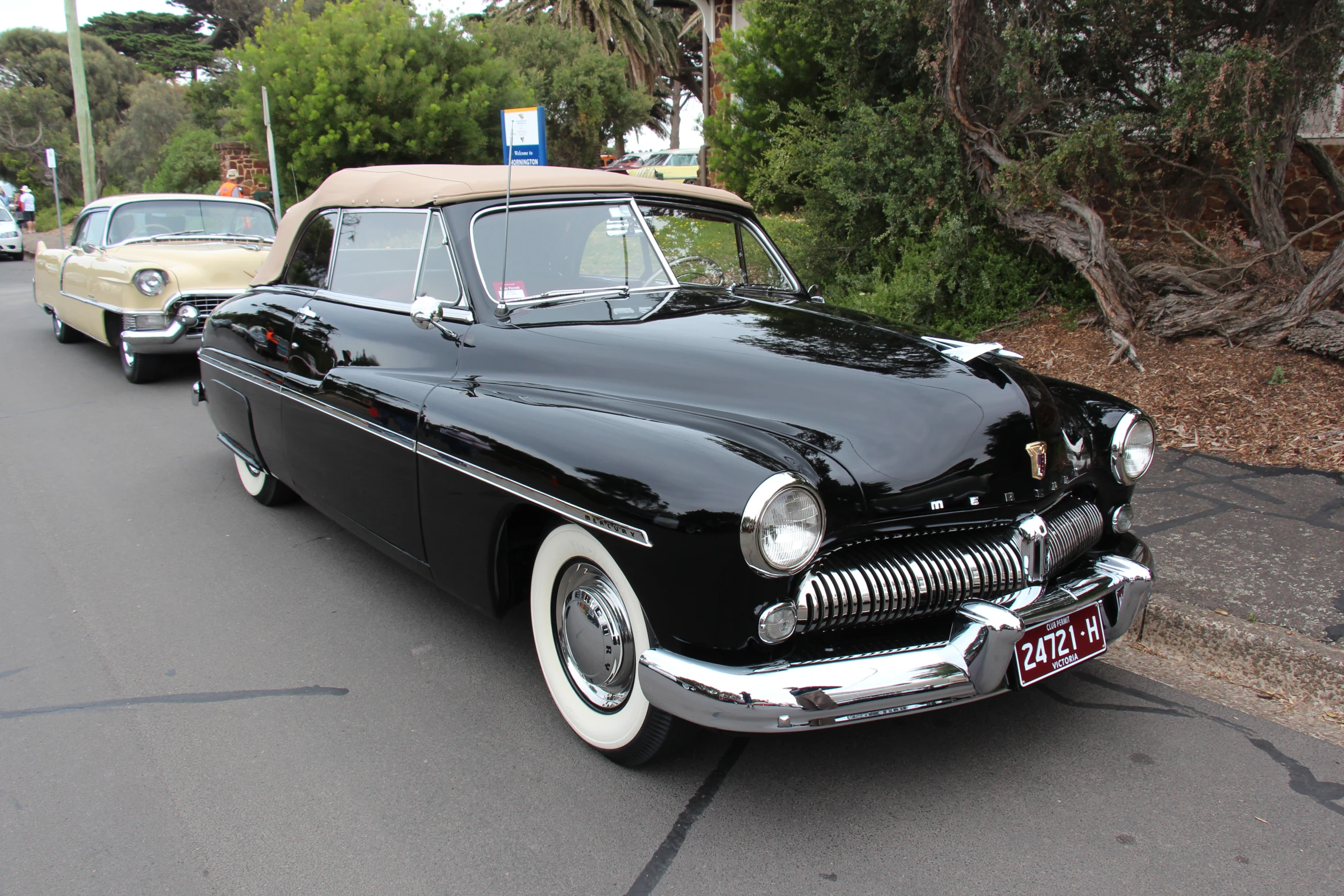 old black car is driving down the road