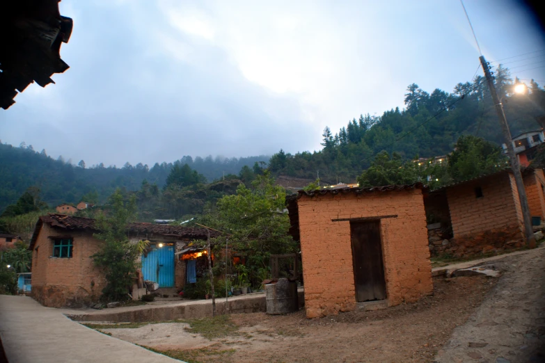 a scenic view of some small buildings and mountain