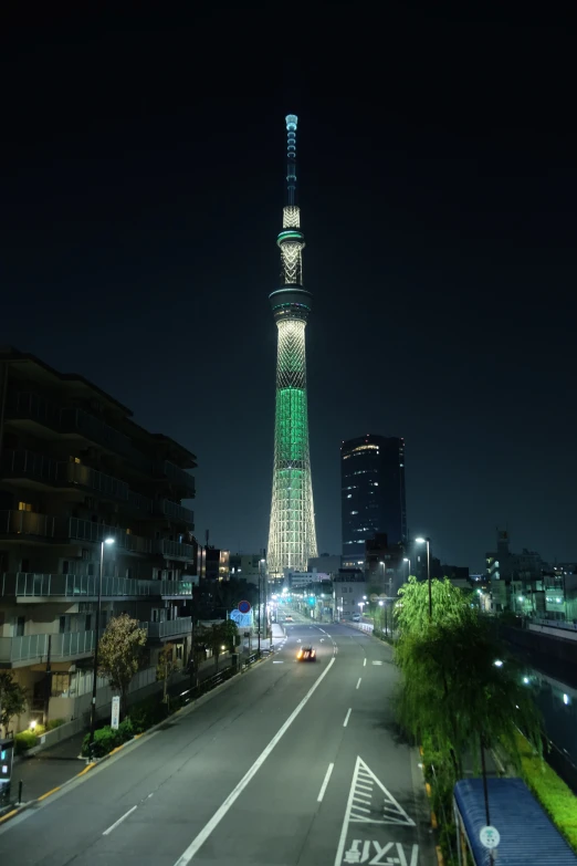 view of an illuminated, street - side tower in the city