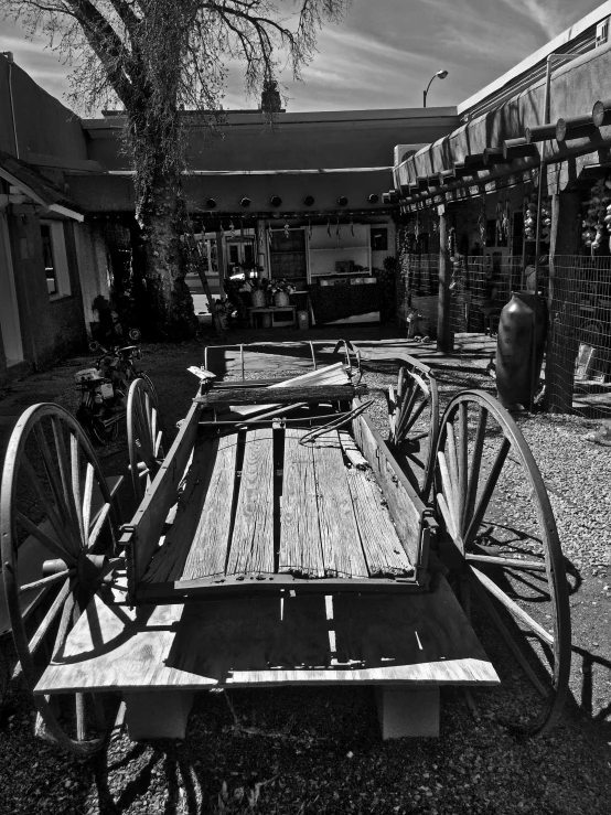 a wooden table topped with wheels under a canopy