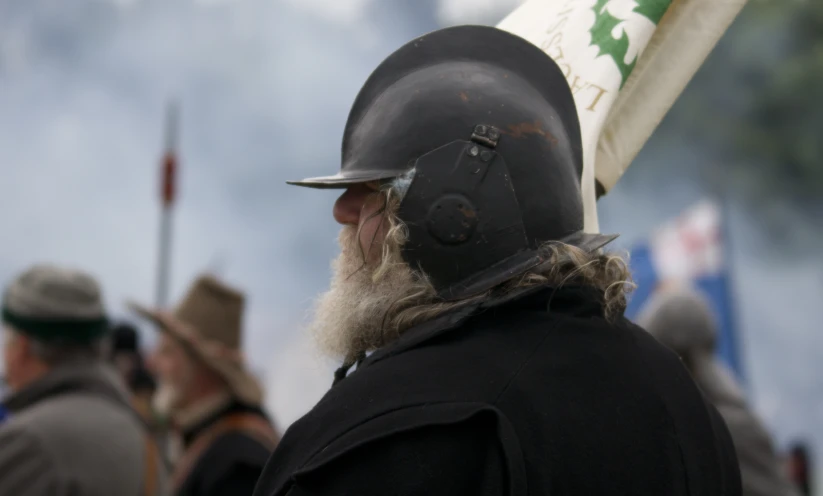 man with long white beard wearing a medieval helmet, holding a baseball bat