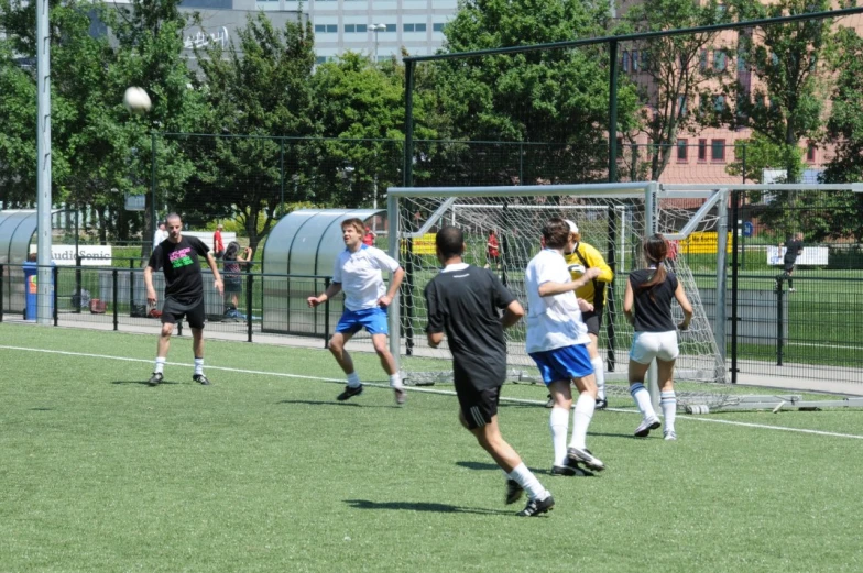 soccer players running around in a grassy area