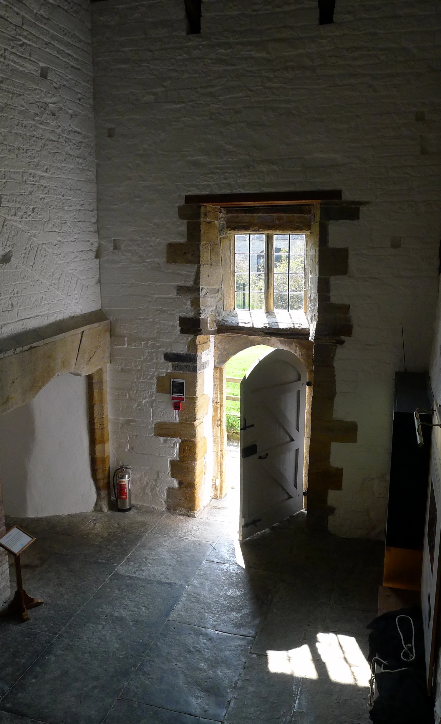 an empty room with a stone archway