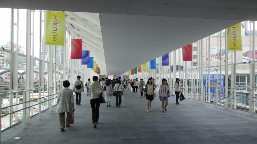 a group of people walking down a long walkway