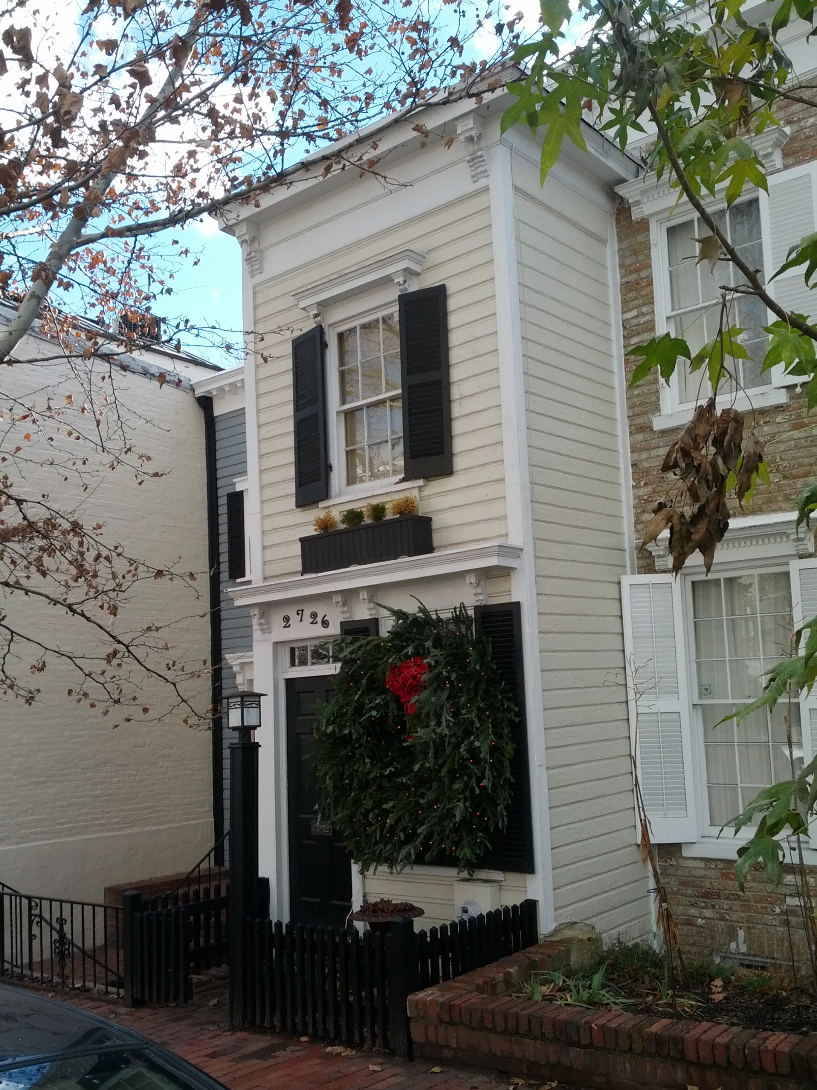 a building with two stories and a black door