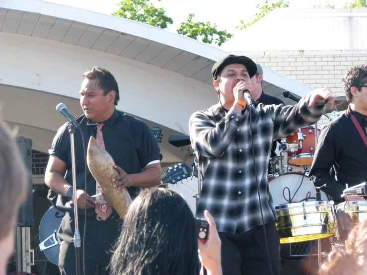 some young men are singing on a stage