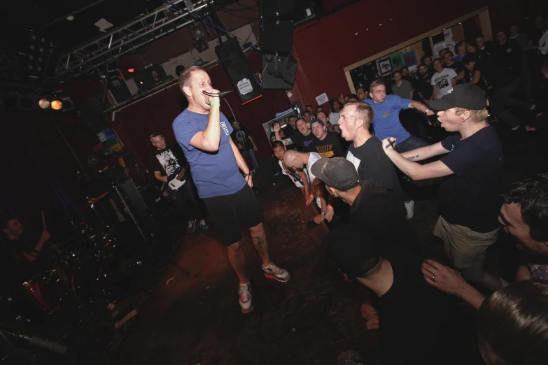 a group of people dancing and having fun in a bar