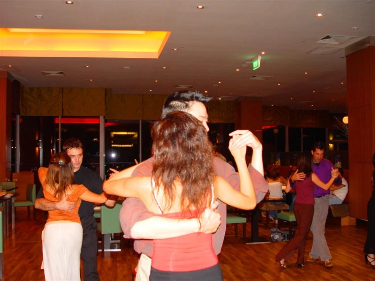 several people dancing and enjoying themselves at a party