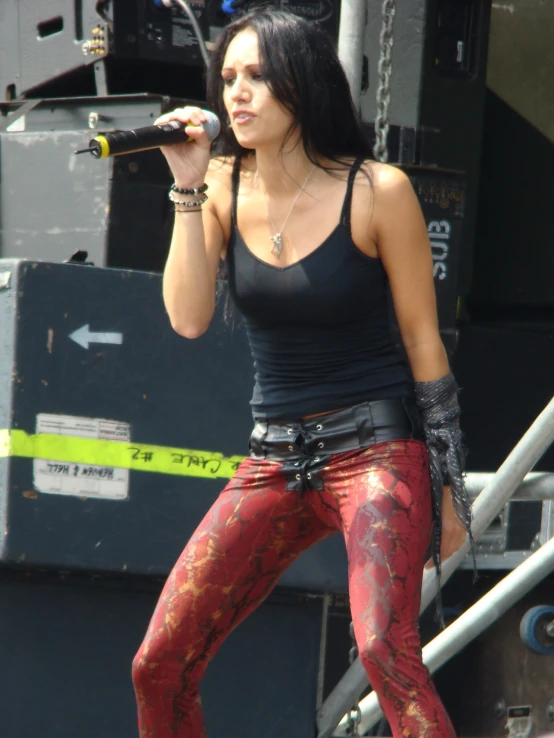 woman in wetsuits holding up a microphone