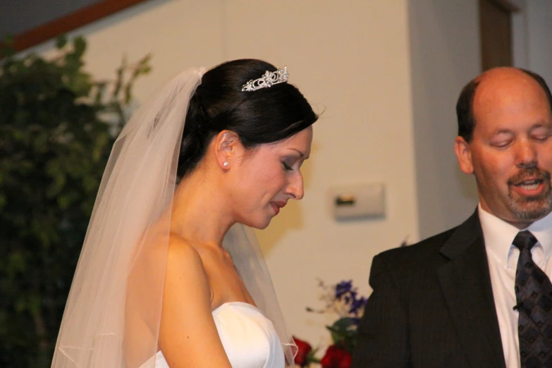 a man and woman standing with a flower in hand