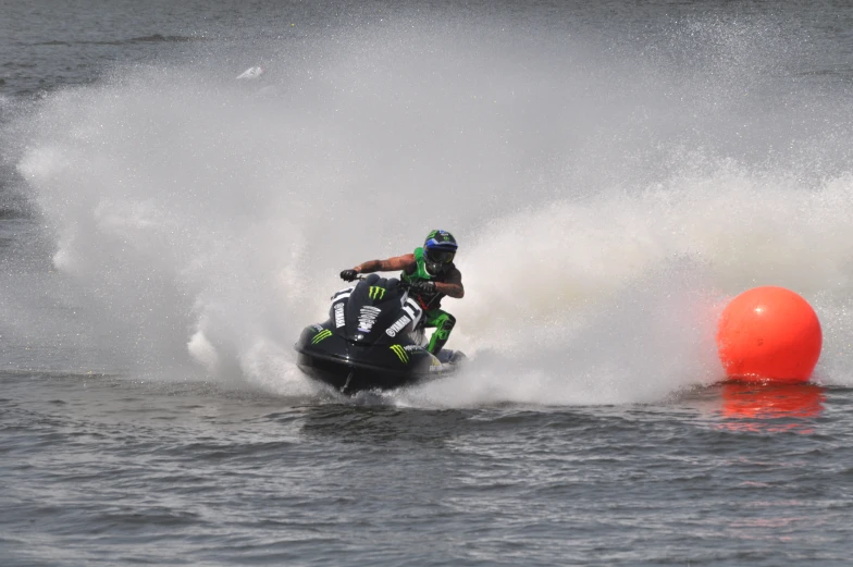 two people on motor bikes racing through the water