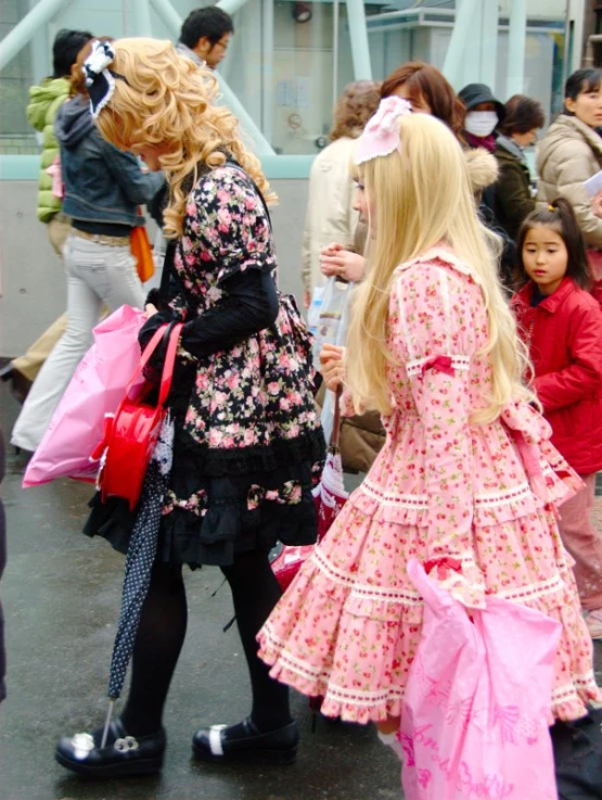 two beautiful blond haired girls holding shopping bags