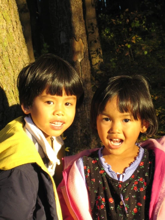 two s stand in front of a tree