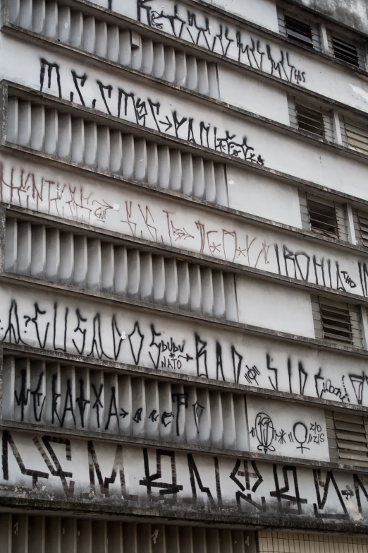 a building with windows and graffiti on it