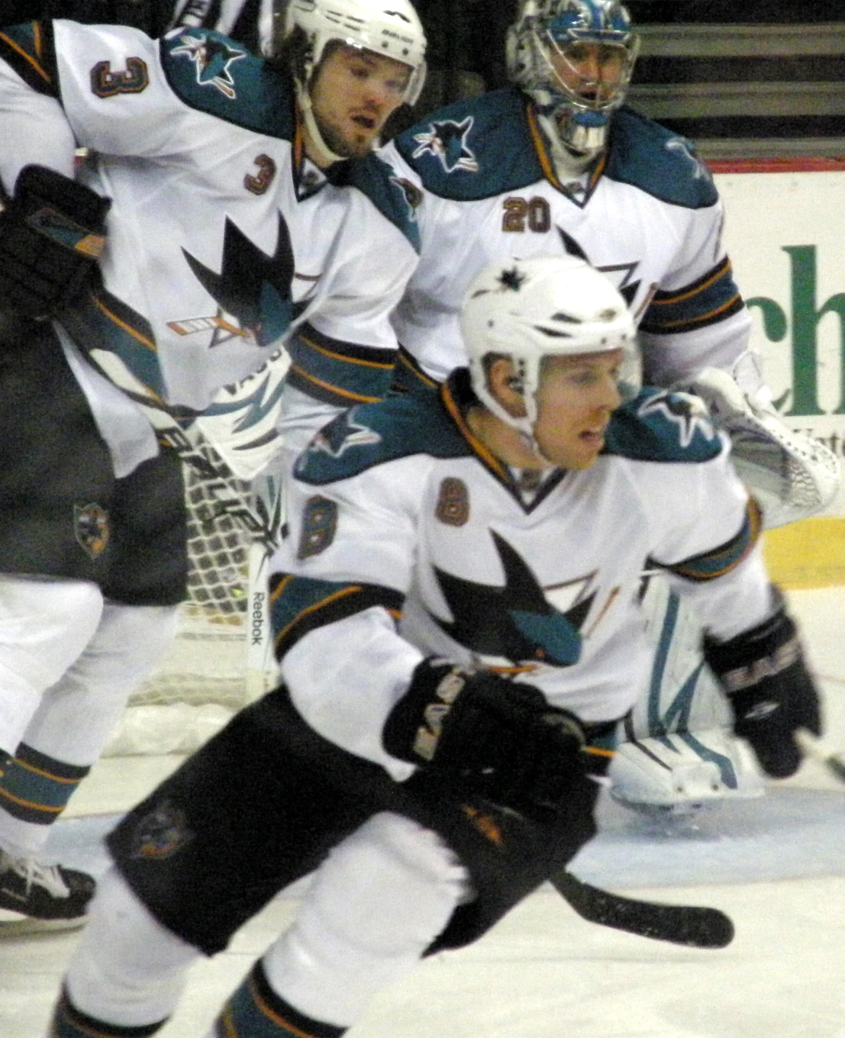 a group of young people playing a game of ice hockey