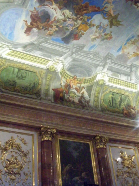 a very elaborate decorated ceiling above ornate doorways