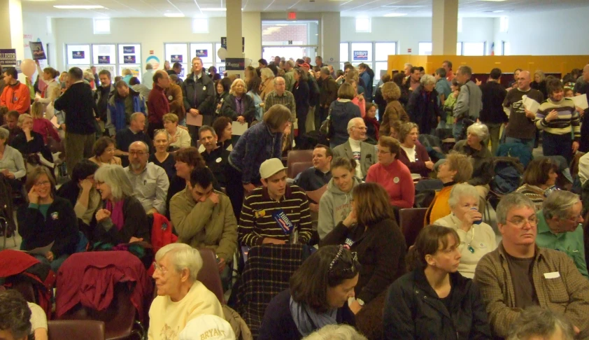 many people standing in a building