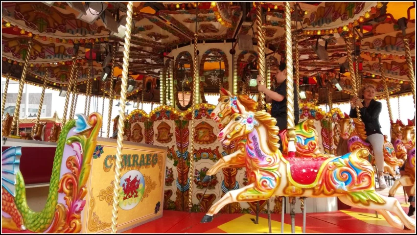 a carousel that has many horses on top of it