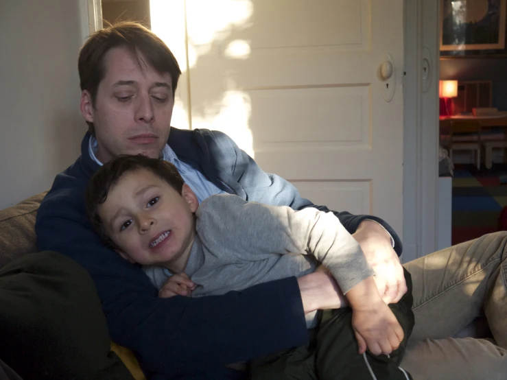 a man and girl are sitting on the couch together