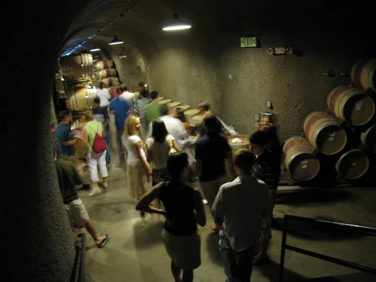 a number of people at a wine tasting