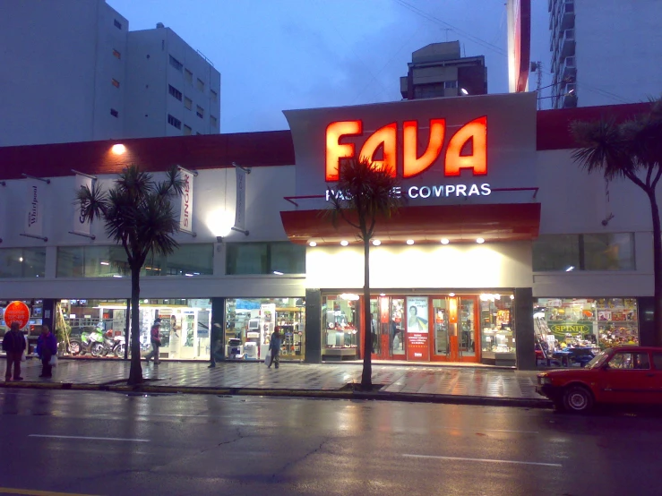 a building with several lights above it and people out front