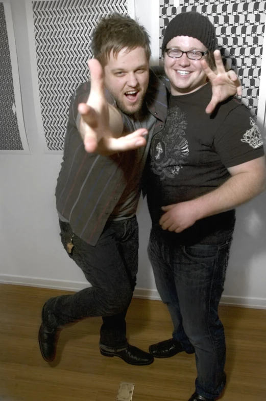 two male s standing with their hands in the air