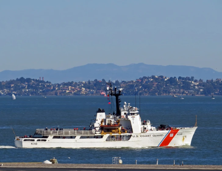 a large boat in the ocean in front of a city