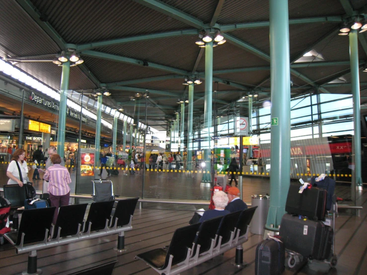 the people are waiting to board their trains