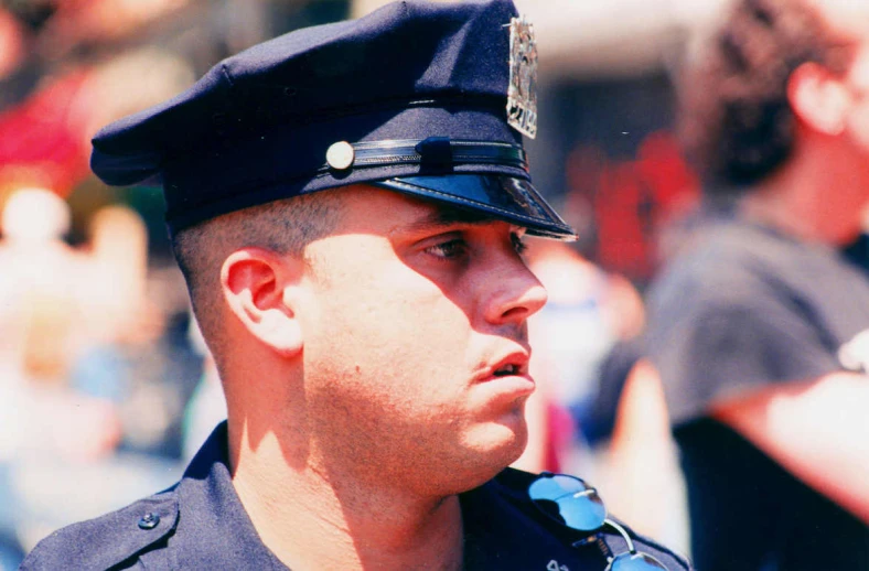 a man in a uniform stands behind a crowd