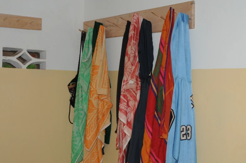 a rack with towels hanging from the wall