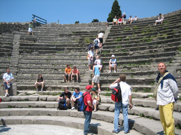 a group of people standing around some stone steps