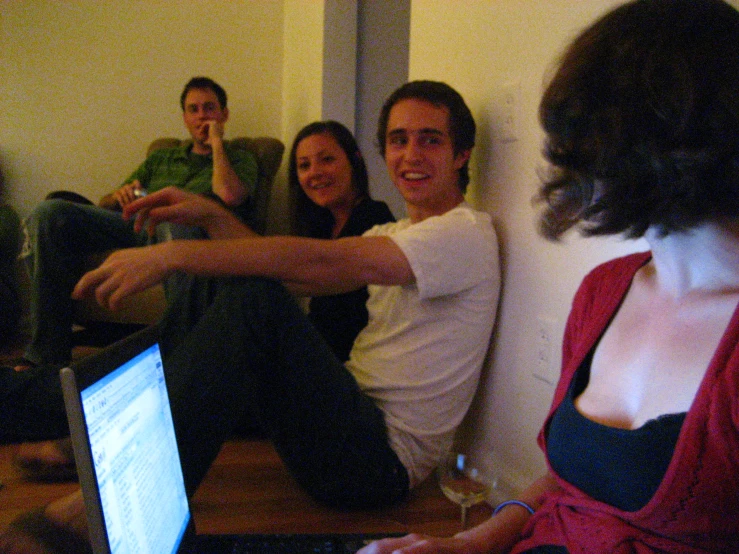 several people sitting in a group and one woman pointing