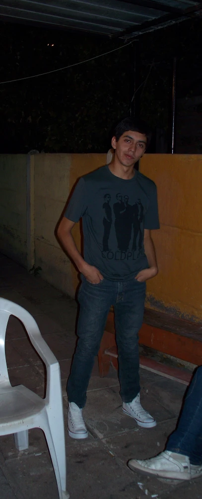 a young man poses for a pograph in his backyard